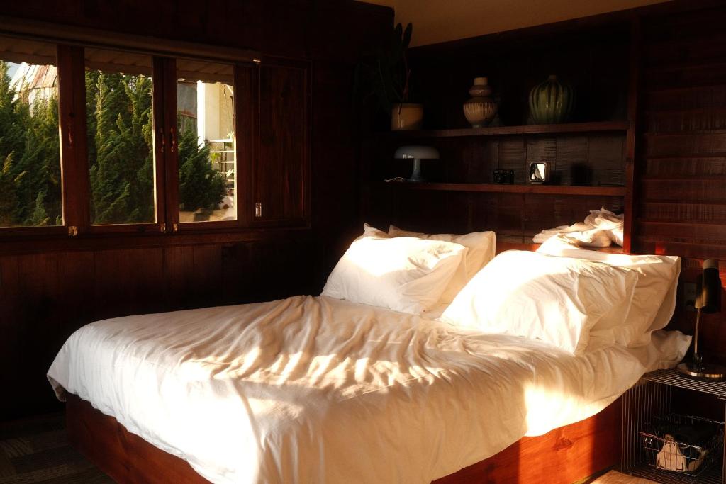 a bedroom with two beds with white sheets at SIA Home - Dalat Haus in Ấp Ða Lợi