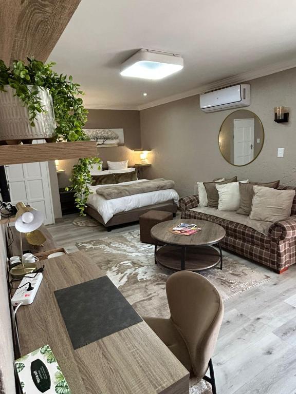 a living room with a couch and a table at Executive en-Suite - Southgate in Southgate