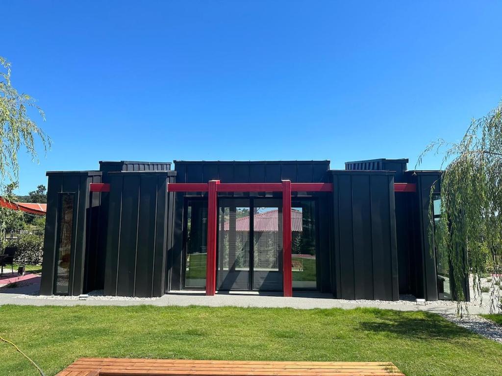 a black and red building with glass doors at Baraka Suite in İznik