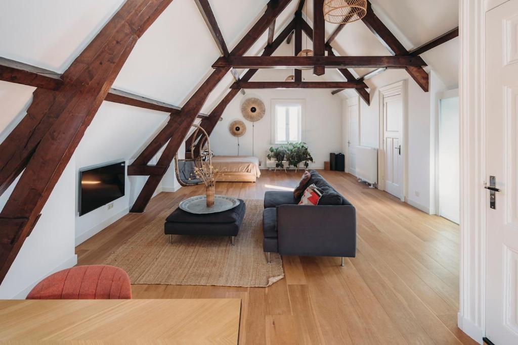 a large living room with wooden beams at Big loft 100m from beach in Scheveningen