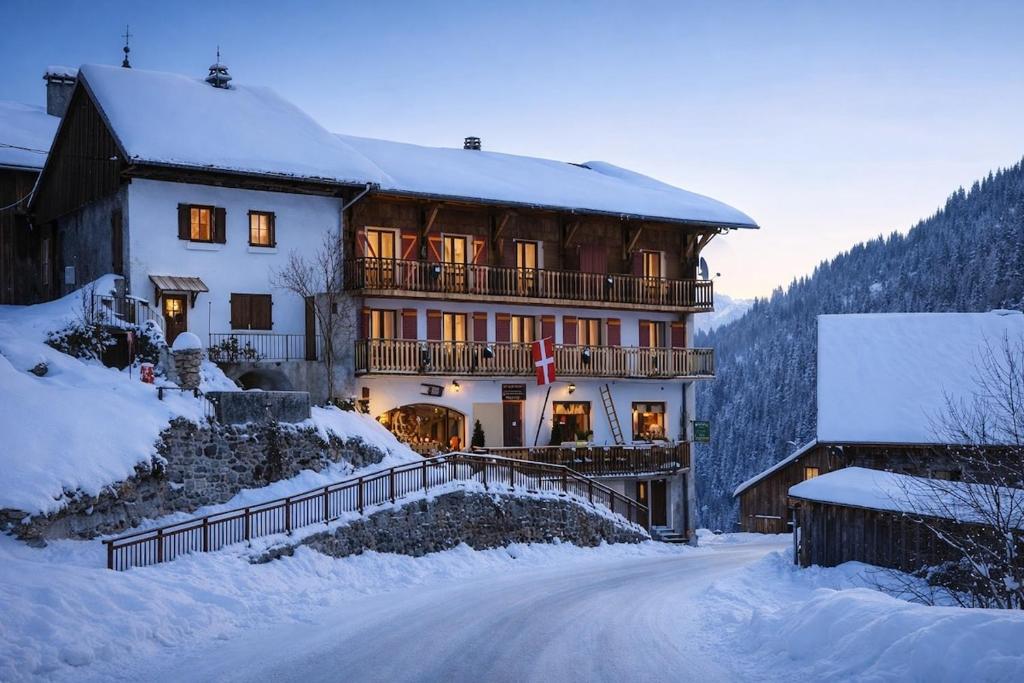 a large house in the snow on a snowy road at Splendid ski-in,ski-out historical chalet! in La Lechere