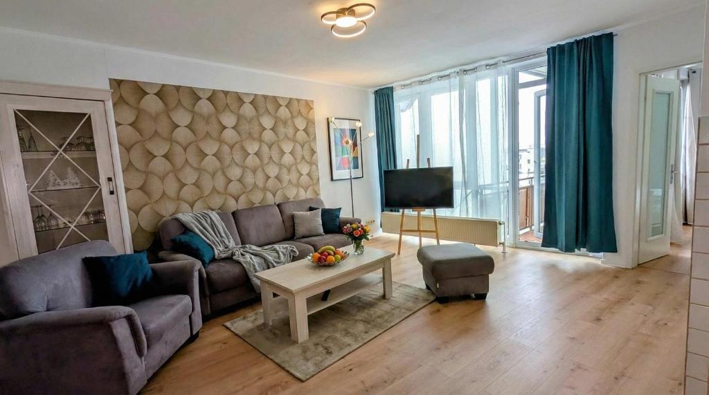 a living room with a couch and a table at FeWo Jette in Warnemünde