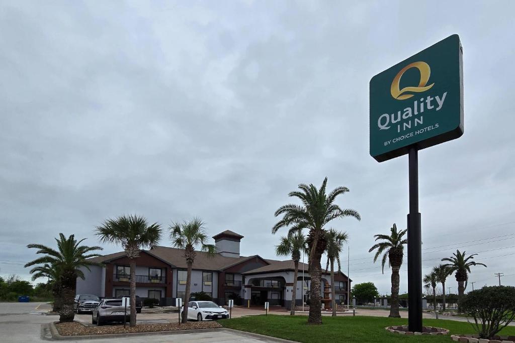 a sign for a quality inn in front of a house at Quality Inn Ingleside - Corpus Christi in Ingleside