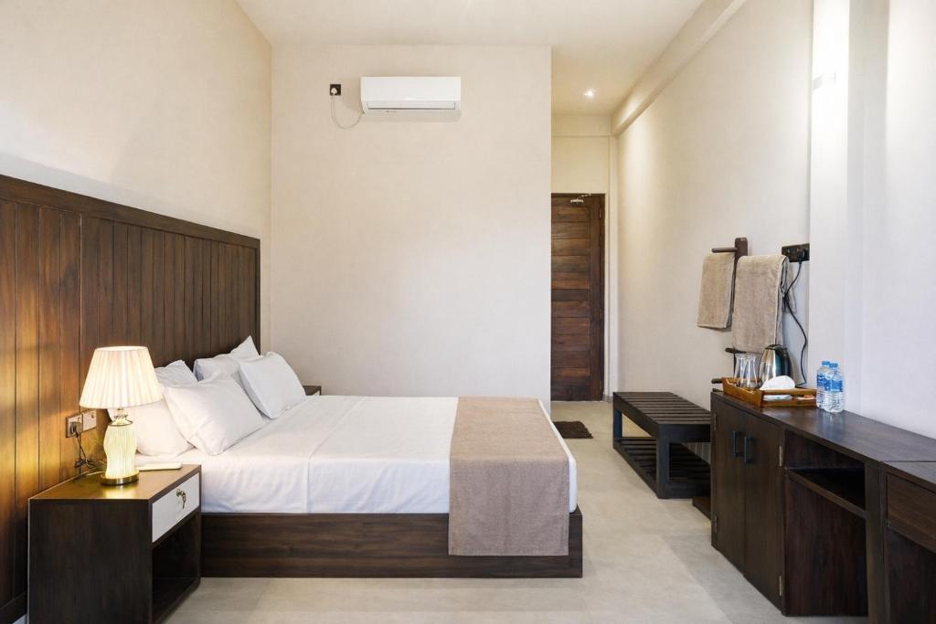 a hotel room with a bed and a desk at Jackhill Hiriketiya in Dickwella