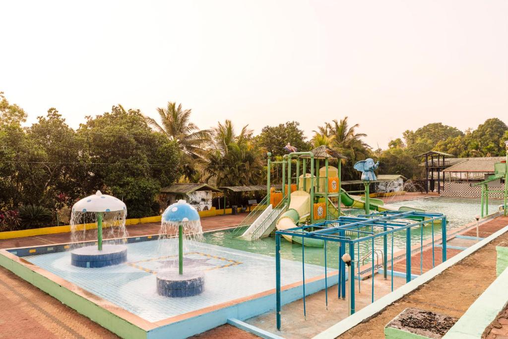 a water park with a slide and a water slide at Treebo Pratham Inn Water Park Resort With Swimming Pool in Kundapur