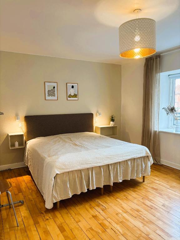 a bedroom with a large bed in a room at Vejle Liv in Vejle