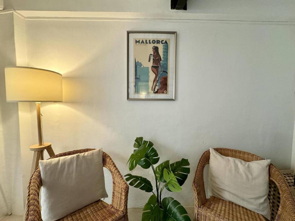 a room with two chairs and a lamp and a plant at Casa Borguny - House in the centre of Palma in Palma de Mallorca