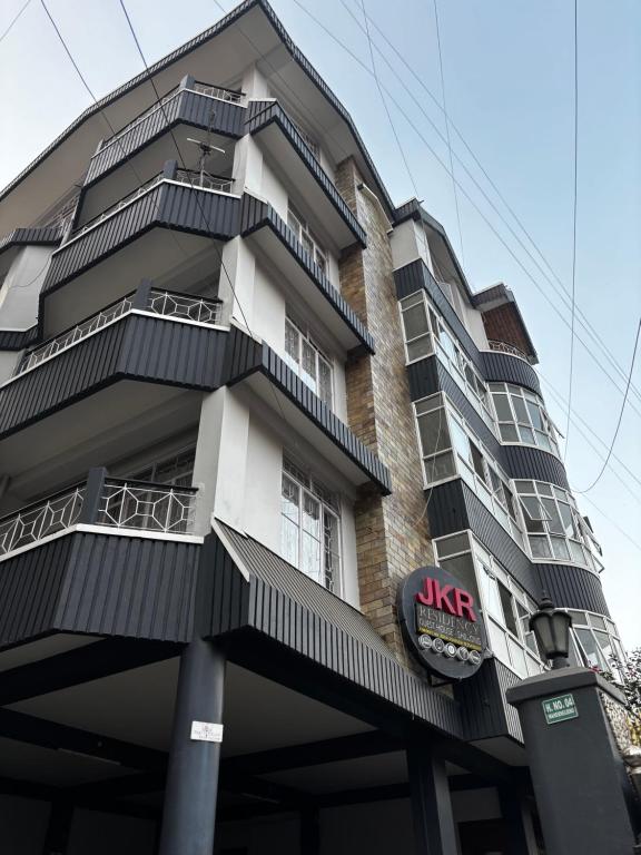 a tall building with balconies and aike sign on it at JKR residency in Shillong