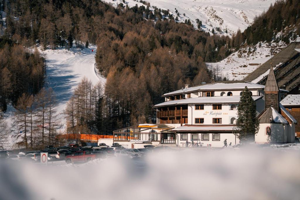 a building on a mountain with a snow covered slope at Sporthotel Kurzras in Maso Corto