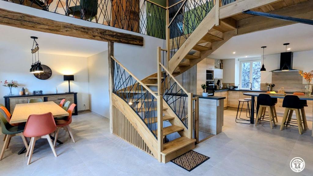 a kitchen and dining room with a staircase in a house at Chez le Paul Jacques in Seigny