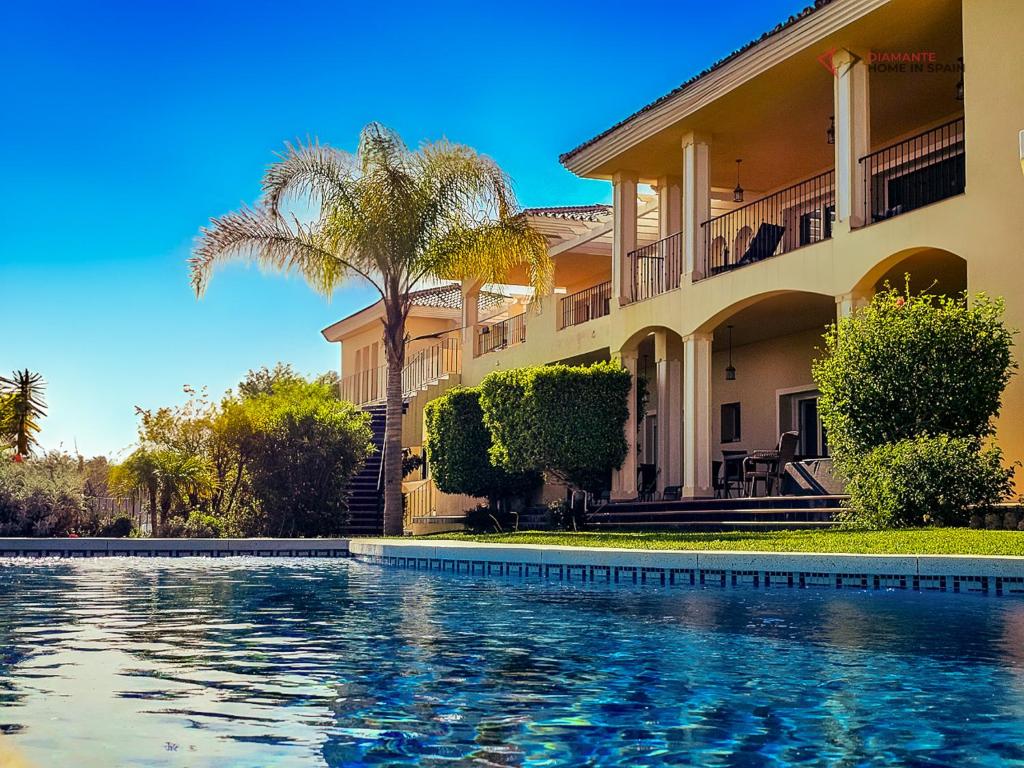 a house with a swimming pool in front of it at Diamante Villa Mijas in Mijas