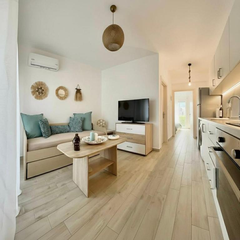 a living room with a couch and a table at Danai Apartment with pool Access in Ofrínion