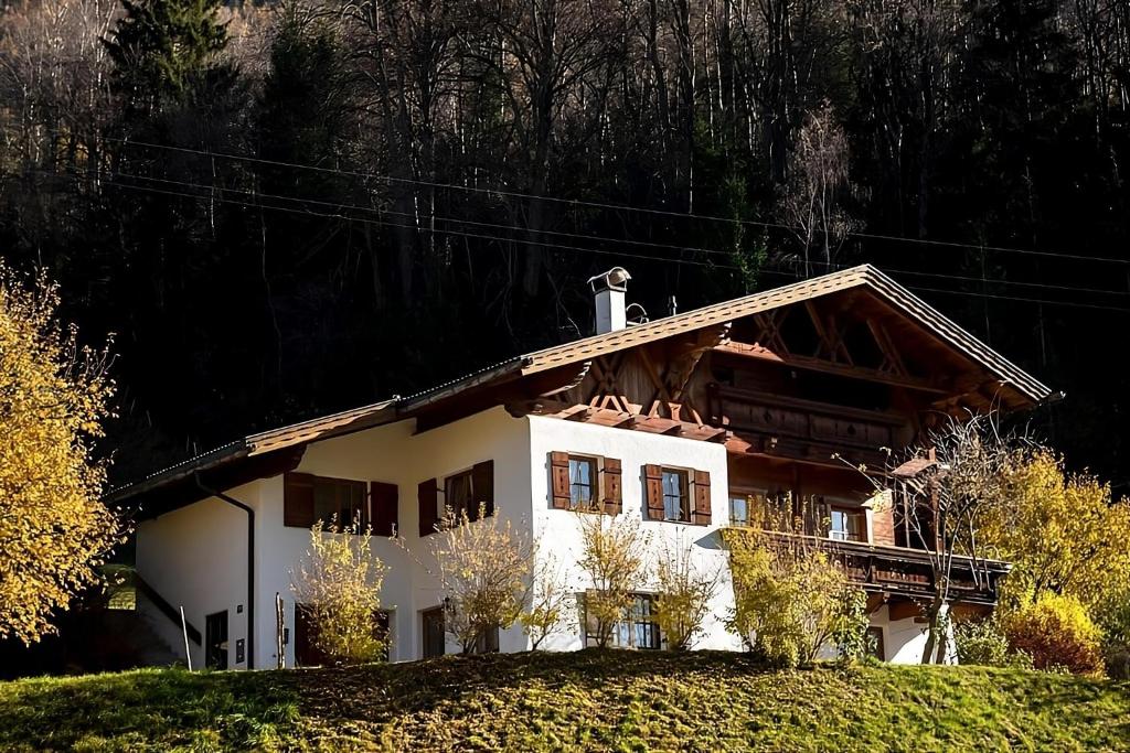 a white house on top of a hill at Ferienhaus-Pitztal in Wenns