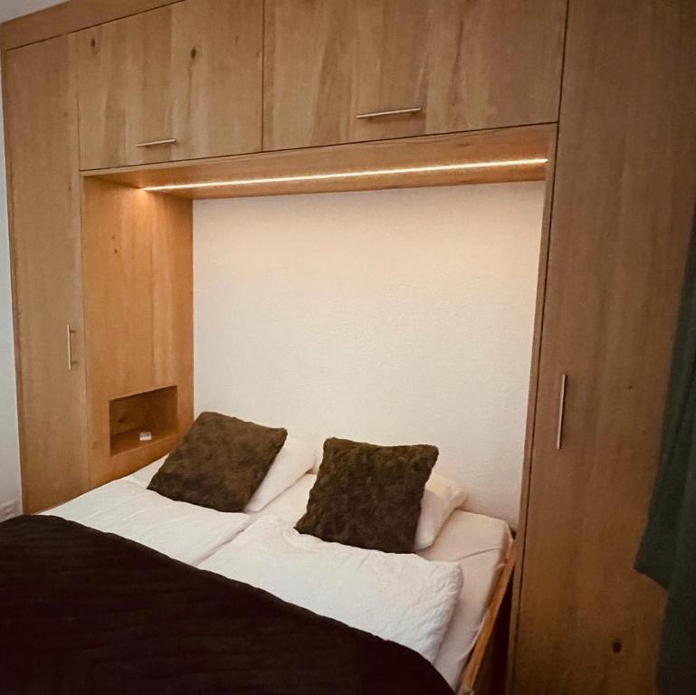 a bed with two pillows on top of it at Studio Vitalis in Zermatt