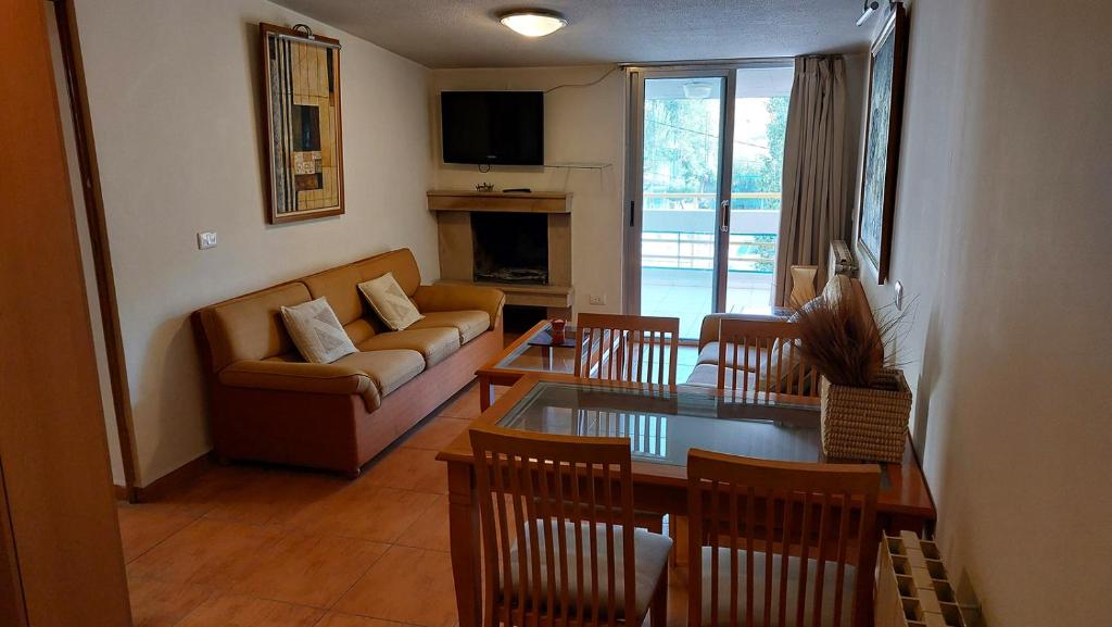 a living room with a couch and a table at 2-Bedroom Chalet for Ski and Summer in Kfardebian