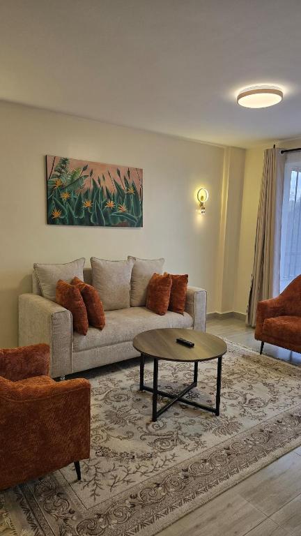 a living room with a couch and a coffee table at Jenn Suites - Nakuru Town in Nakuru