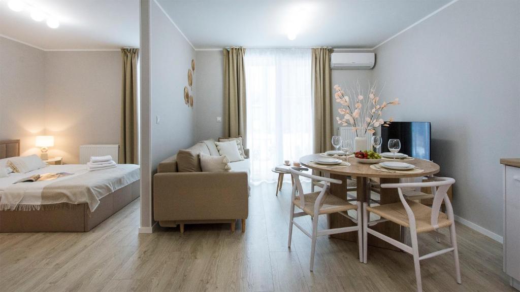 a room with a table and a bed and a bedroom at Baltic Line - Pomerania in Gdańsk