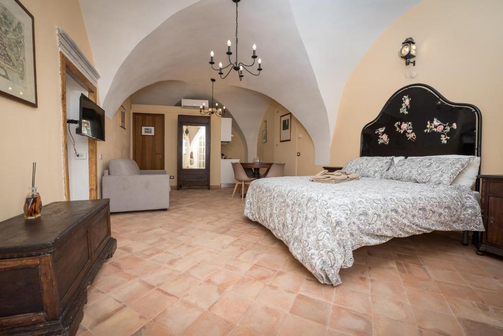 a bedroom with a bed and a table and a chair at Residence Fusconi in Norcia