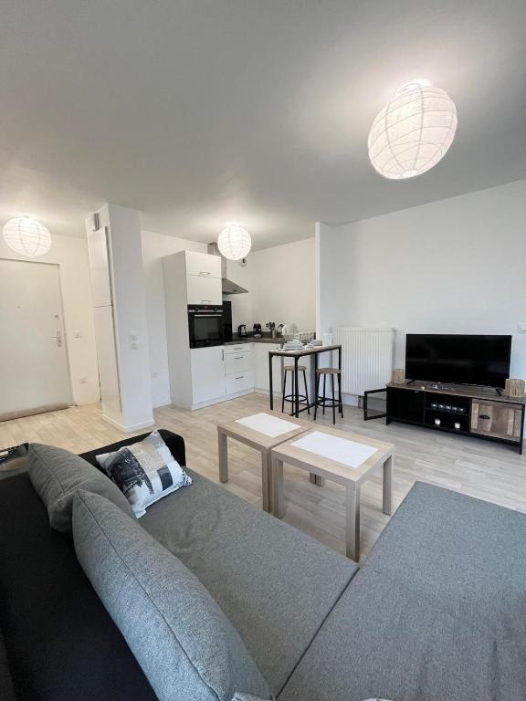 a living room with a couch and a kitchen at Villeneuve, in Villeneuve d'Ascq