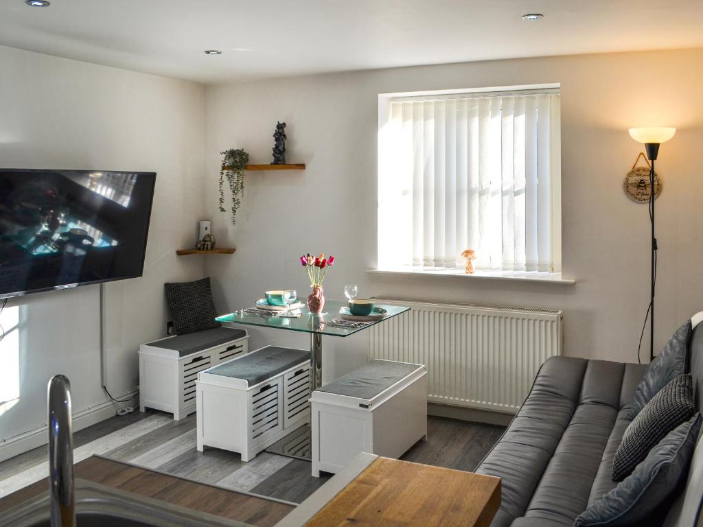 a living room with a table and a couch at Holly's Apartment in Beverley