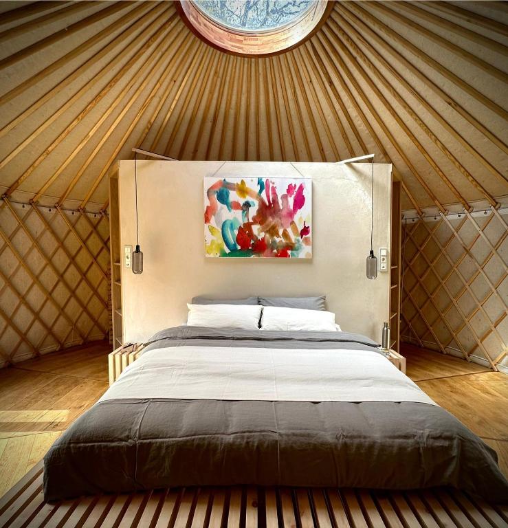 a bedroom with a large bed in a yurt at ASTRAEA Jurt Village in Arendsee