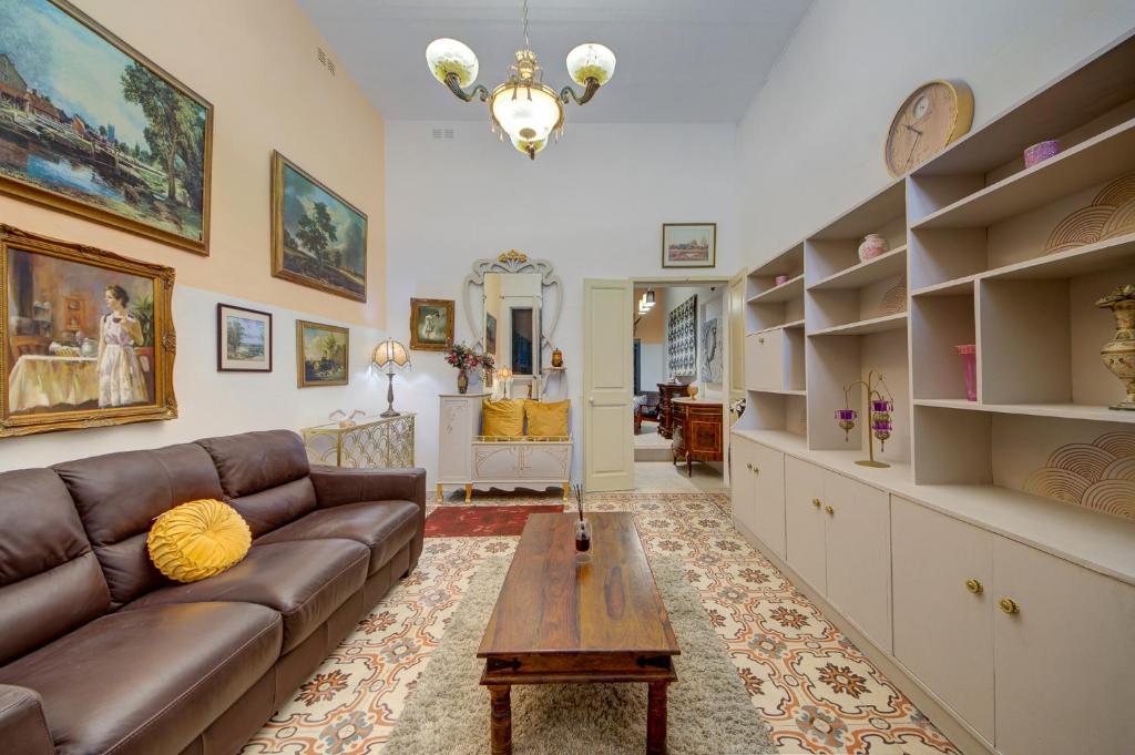 a living room with a couch and a table at Charming Central 2BR Townhouse with Rooftop Terrace in St. Julianʼs