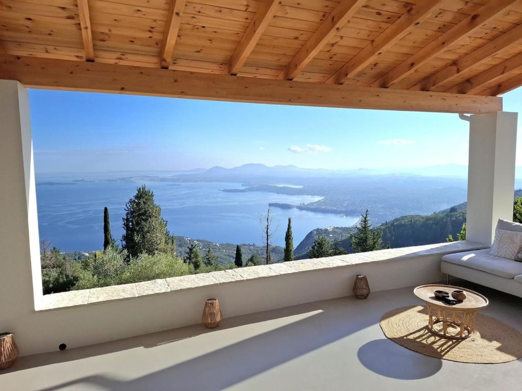 a large window in a living room with a view at Villa Kalivista in Spartýlas