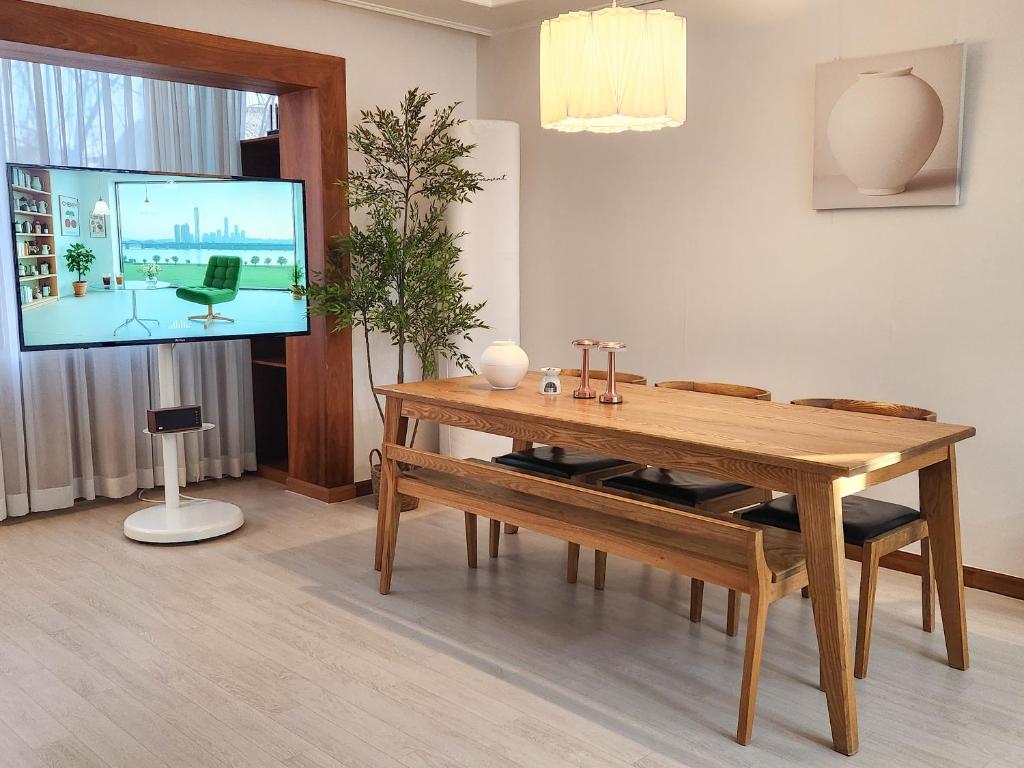 a living room with a table and a flat screen tv at Kintex Central Stay 3BR 2Bath Spacious Space in Ilsan-yŏk