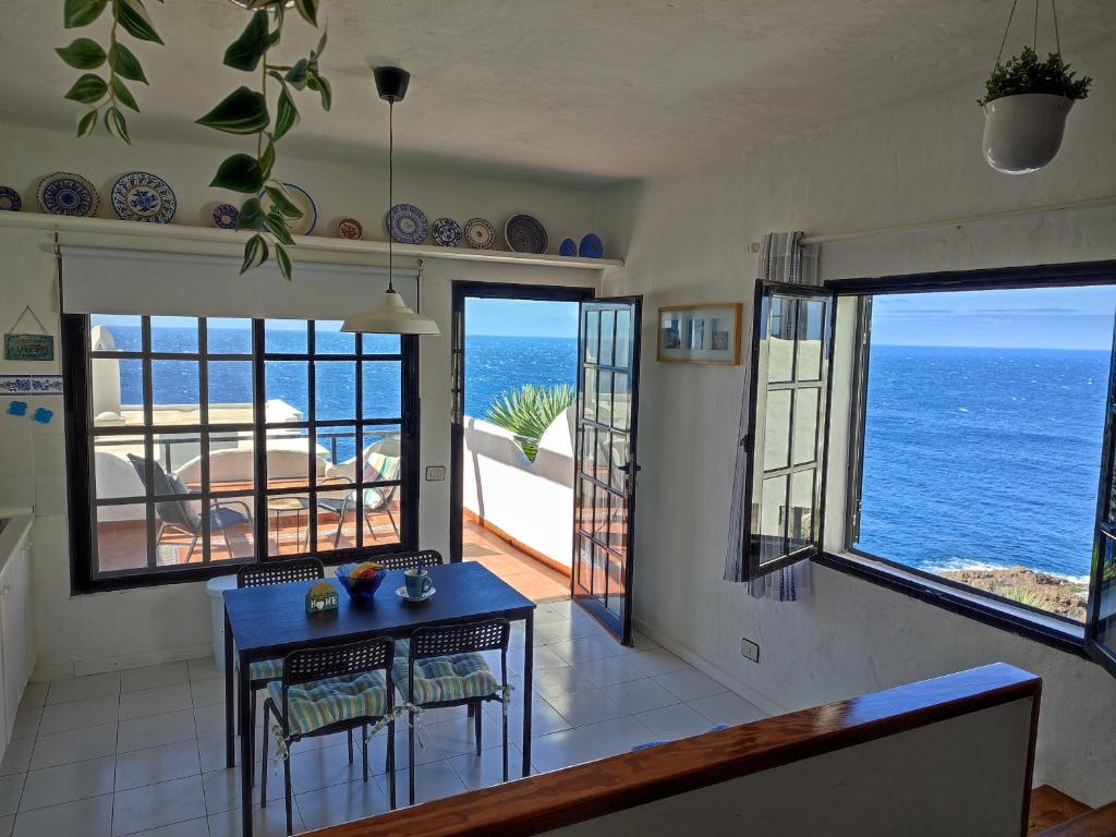 a kitchen with a table and a view of the ocean at Vista Mar Sardina in Gáldar