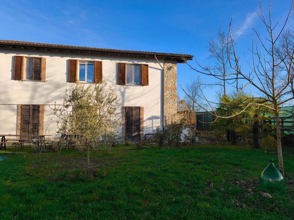 a house with a yard in front of it at Casa Del Colle in Casasco