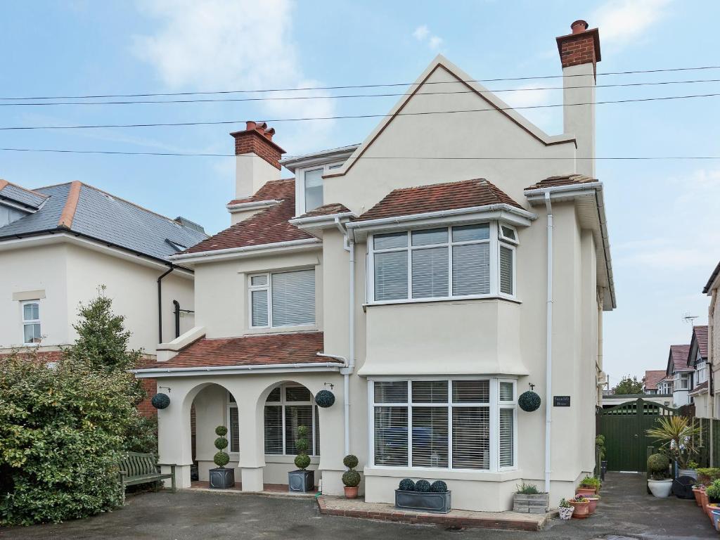 a white house with a red roof at Stourcliffe House in Bournemouth