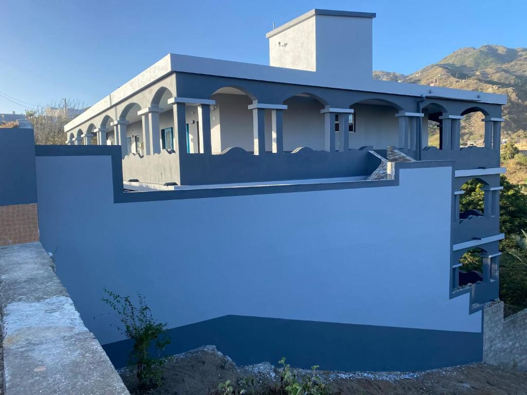 a house painted blue with a fence at Djabraba's Triplex in Vila Nova Sintra