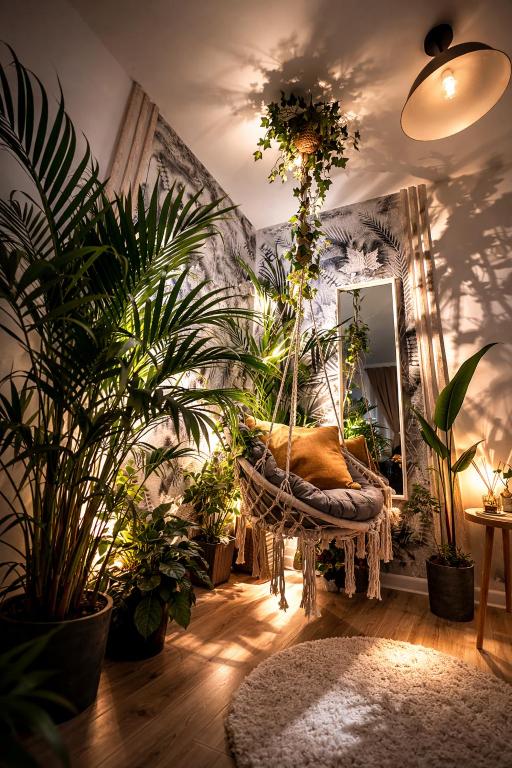 a room filled with lots of plants and a swing at VerdeViu Apartments 1 Prima Residence Universitatii in Oradea