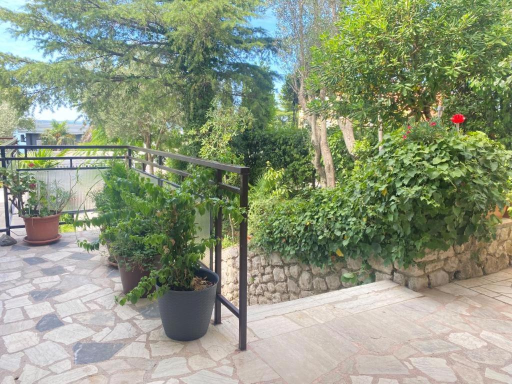 a patio with potted plants and a fence at Fran in Crikvenica
