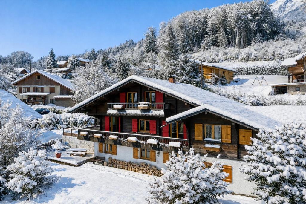 a house covered in snow with snow covered trees at Le Chalet des 3 Monts in Les Clefs