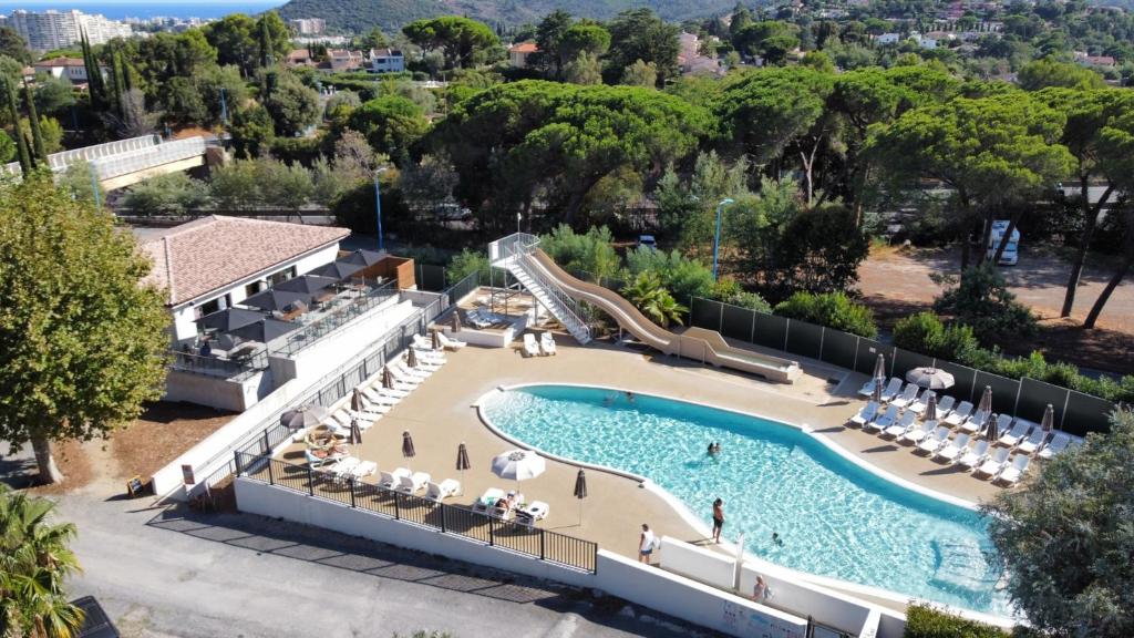 an overhead view of a resort pool with a slide at Camping La Provençale - Maeva in Mandelieu-La Napoule