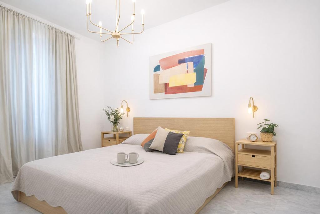 a bedroom with a bed with two mugs on it at Hotiday Rapallo Old Town in Rapallo