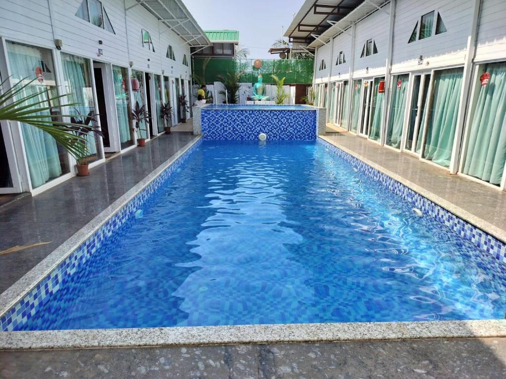 a swimming pool in the middle of a building at Bay View Resort in Anjuna