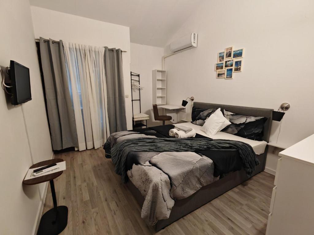 a bedroom with a bed and a desk in it at Villa Finera in Premantura