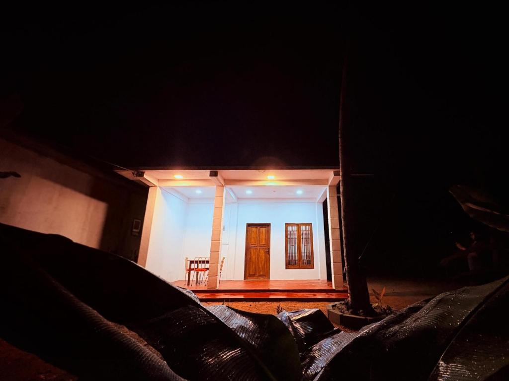 a small house with a door in the dark at Shan Villa Dambulla in Dambulla