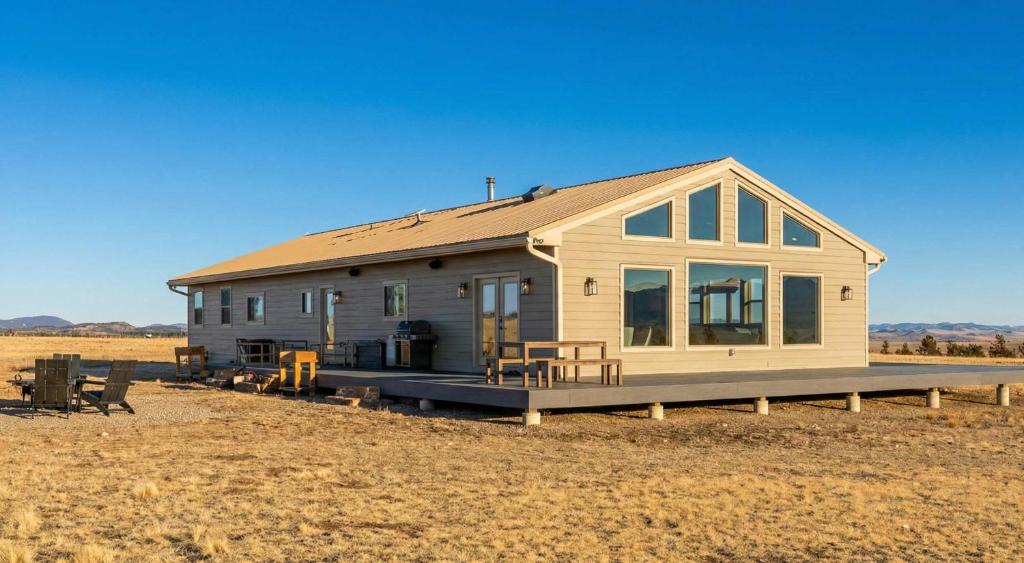 a tiny house sitting in a field in the desert at Luxury Off-Grid Cabin with Stargazing Deck & Views in Fairplay