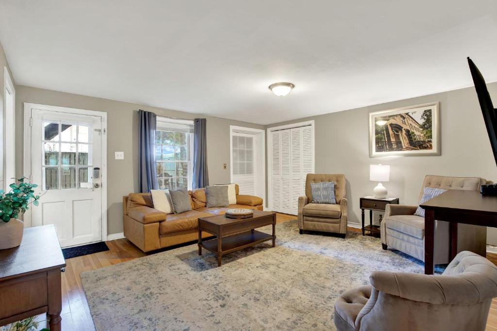 a living room with a couch and chairs and a table at Oglethorpe Manor Garden Level in Savannah