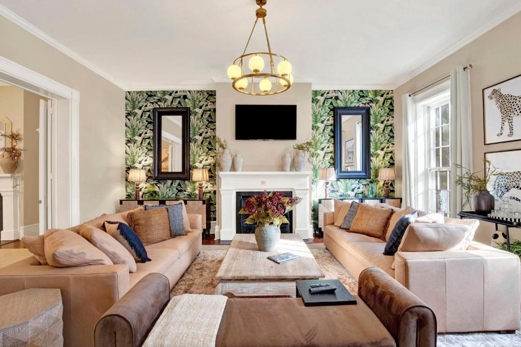 a living room with a couch and a fireplace at Oglethorpe Manor Main House in Savannah