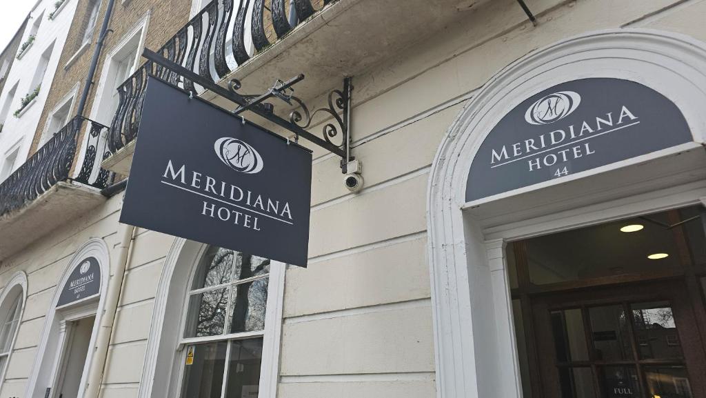 a sign on the side of a building at Hotel Meridiana in London