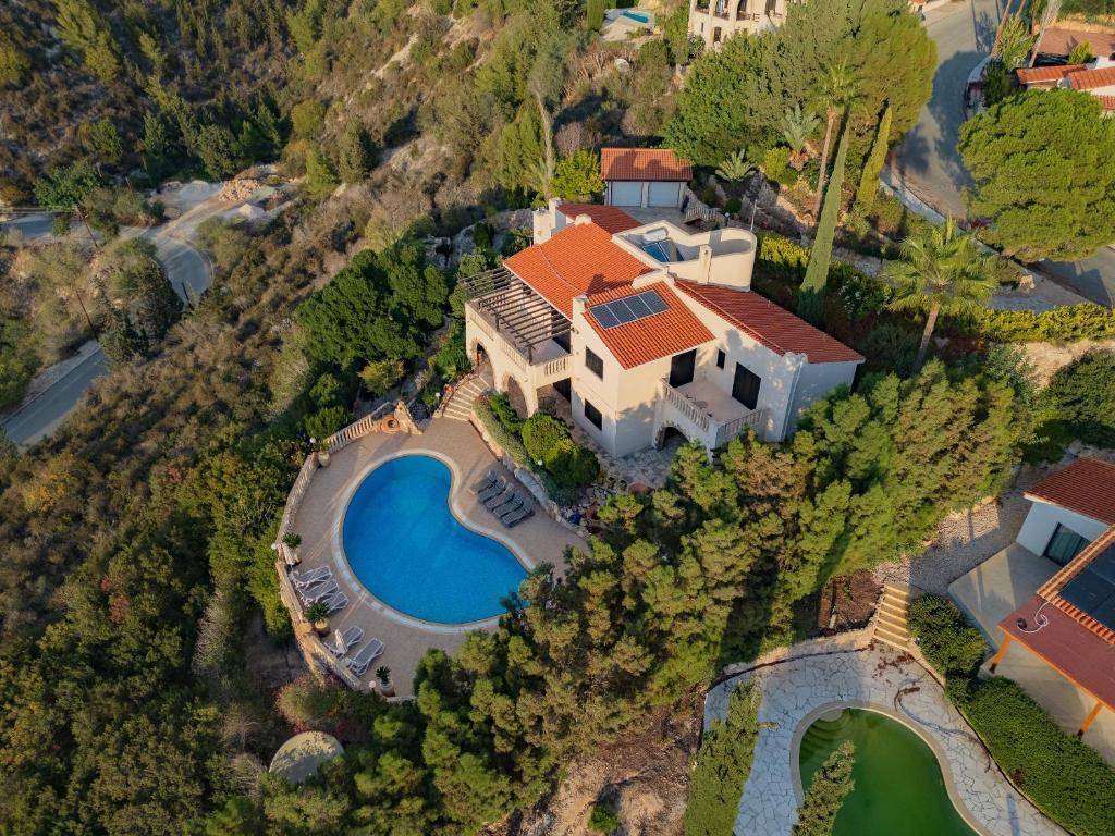 an aerial view of a house with a swimming pool at Resitour - Kamares Village in Paphos