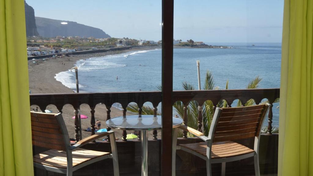 a table and chairs on a balcony with a view of the beach at La Playa 2 B in La Laja