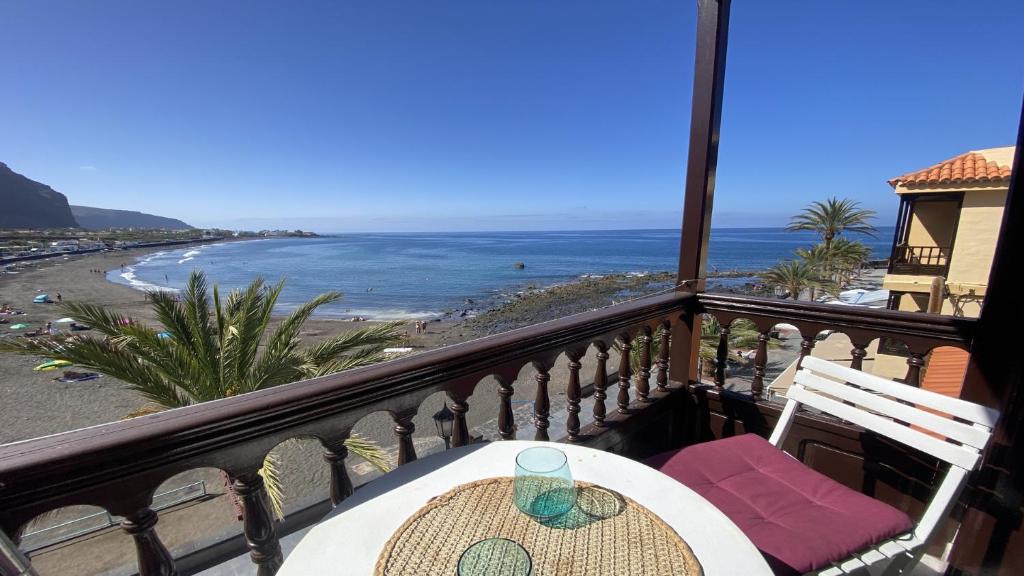 a table and chairs on a balcony with a view of the beach at La Playa 2 A in La Laja