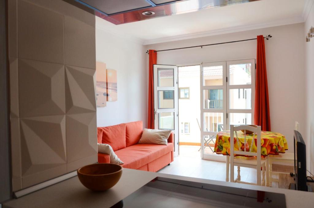 a living room with a orange couch and a window at Paquita in La Laja