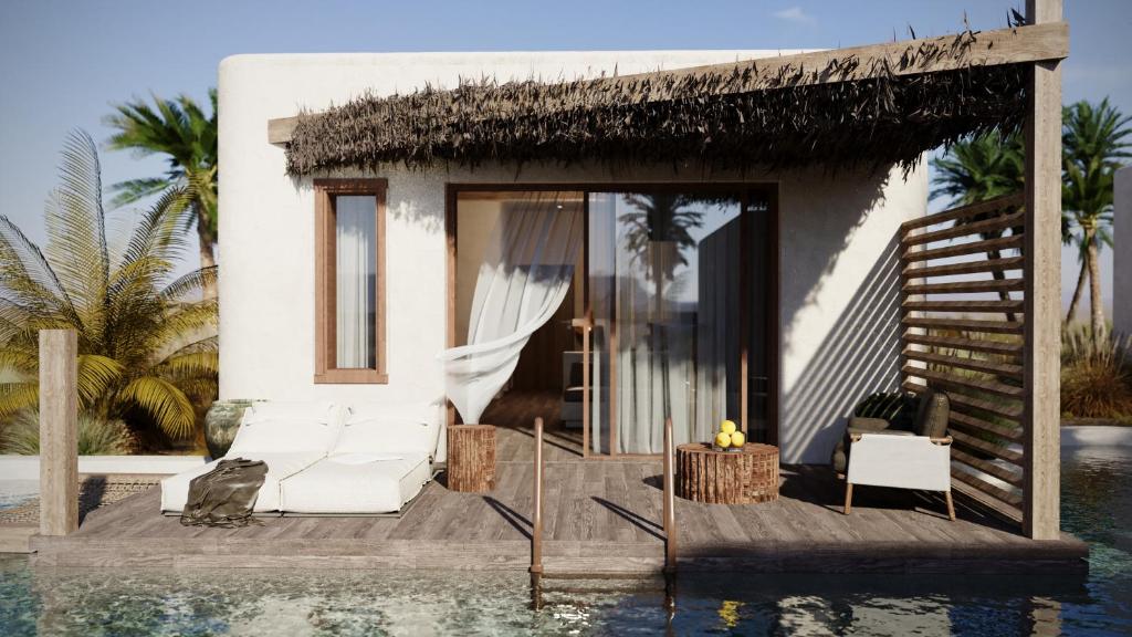 a villa with a swimming pool next to a house at Eden Island in Agia Paraskevi