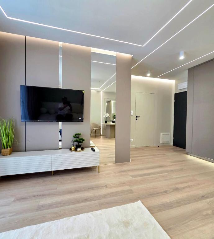 a living room with a large flat screen tv on a wall at Apartament Ostródzka in Iława